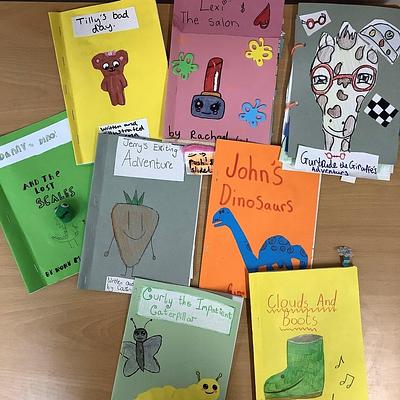 Eight homemade books with colourful covers illustrated by children